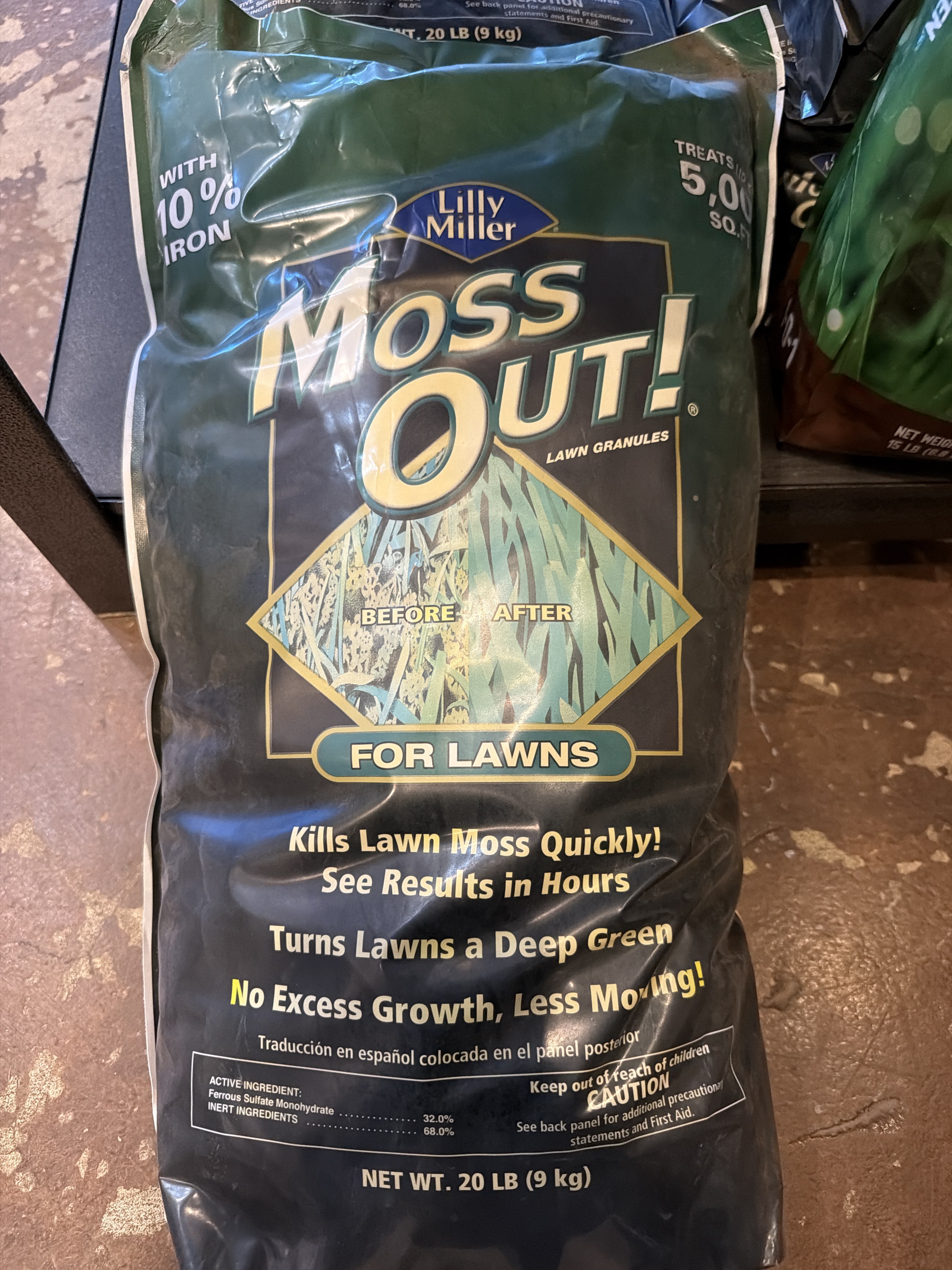 A 20-pound bag of Lilly Miller Moss Out For Lawns Lawn Granules photographed in a retail display.